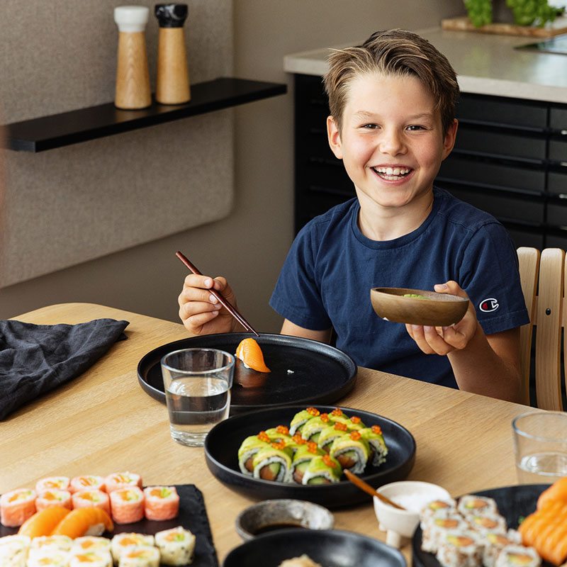 Boy eating sushi. Photo
