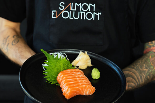 Chef serving Salmon Evolution sashimi. Photo